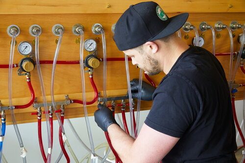 Worker installing draft beer lines