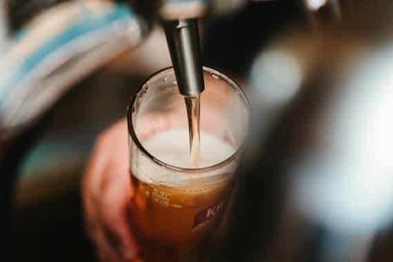 Beer pours from a draft line