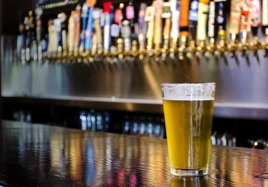 Draft beer with taps in the background
