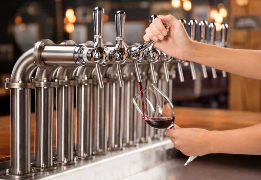 Draft wine being poured from a keg tap