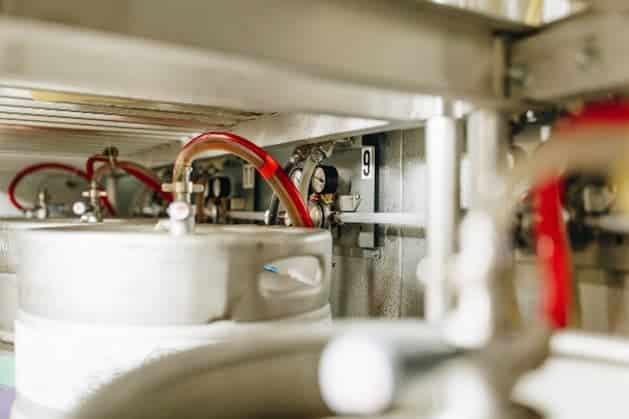 Several kegs with tubing connected