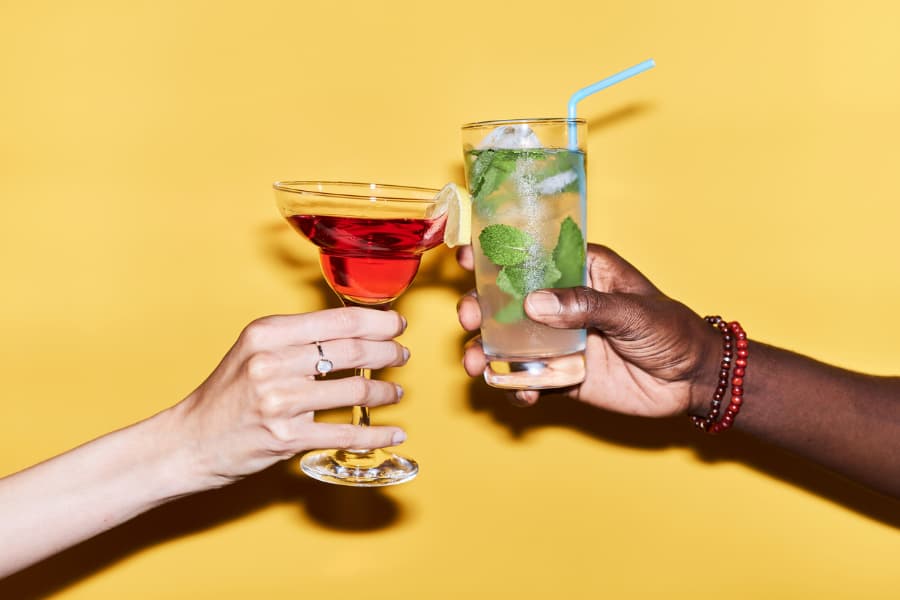 Friends clinking cocktail glasses in celebration