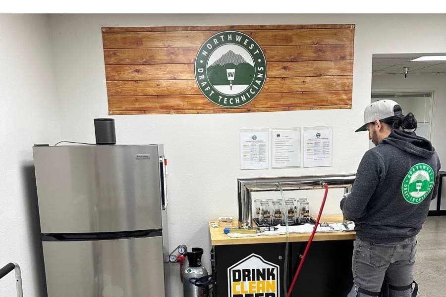 Team member cleaning draft lines
